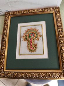 Framed in gelted frameThe painting of traditional Jewellery designs in Marble is done with gold leaf and colored glass. This art has its origin in the royal city of Jaipur  once a design is drawn on marble tile. the frame is 23 x20 cm. the center is 10 x 