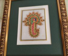Framed in gelted frameThe painting of traditional Jewellery designs in Marble is done with gold leaf and colored glass. This art has its origin in the royal city of Jaipur  once a design is drawn on marble tile. the frame is 23 x20 cm. the center is 10 x 
