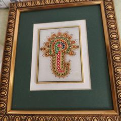 Framed in gelted frameThe painting of traditional Jewellery designs in Marble is done with gold leaf and colored glass. This art has its origin in the royal city of Jaipur  once a design is drawn on marble tile. the frame is 23 x20 cm. the center is 10 x 
