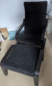 Black IKEA poaug armchair and footstall