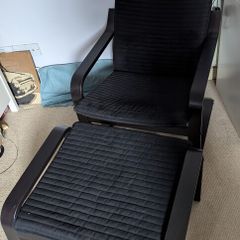 Black IKEA poaug armchair and footstall