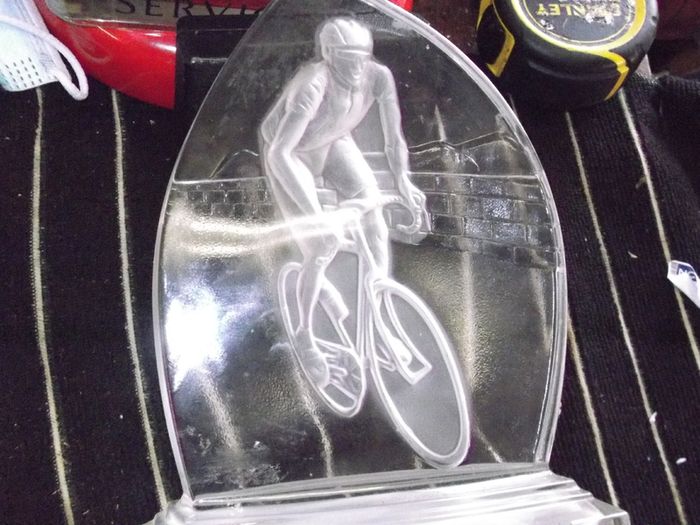 a cut glass with a cycle on it