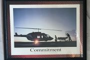 Framed Motivational Commitment Photo showing silhouette patient being loaded into helicopter by ambulance crew.