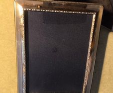 A sterling silver glazed photo frame in total dimensions 8 1/4 x  x 6 1/4 inches take photo 7 x 5 inches. Set with velvet mounts in very good condition.