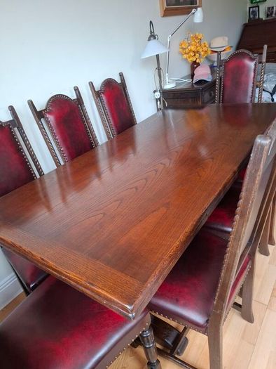 Dark Oak Dining room table and 8 leather chairs.