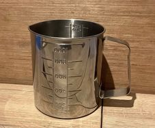 Stainless steel measuring beaker with a handle