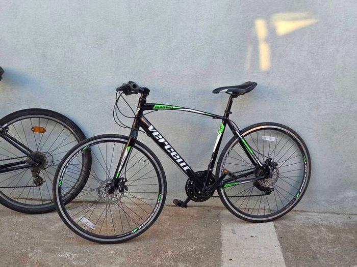 Two bikes one mountain one is a type of racing mountain bike