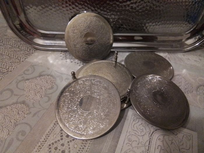 Set of Six Silvered Coasters in a Stand