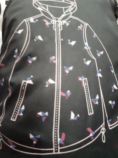New rain coat with tag attached