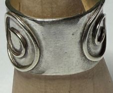 Handmade sterling silver ring. Thick band with Celtic swirl around the band. Size N