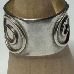 Handmade sterling silver ring. Thick band with Celtic swirl around the band. Size N