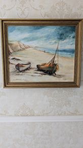 Framed coastal oil painting - boats on beach
