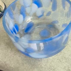 A hand-blown blue and white swirl art glass piece Small glass bowl with sticker say The phrase "EVERY PIECE IS UNIQUE" circles the clover.