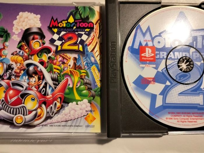 Rogue Trip vacation 2012 + Motor Toon 2 Grand Prix PS1 PlayStation