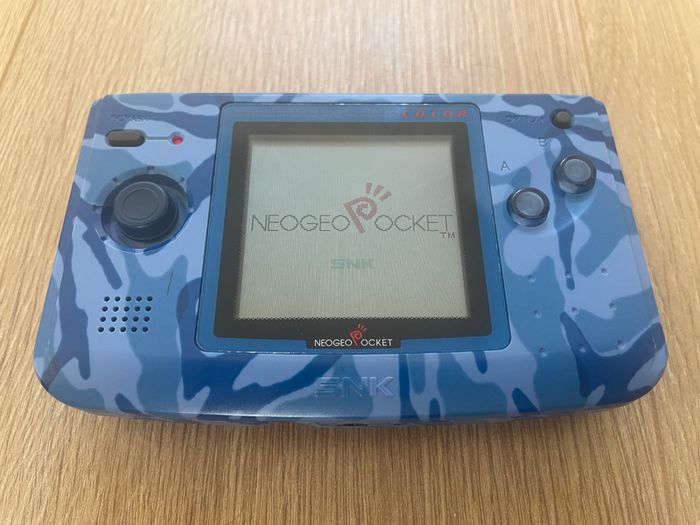 Neo Geo Pocket Color with game SNK vs. Capcom: Match of the Millennium