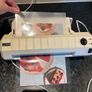 Laminator with laminating pouches Image 3
