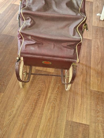 Antique Burgundy Doll's Pram, Manufactured by Walker around the 1940s, It features a Coach-Built Style Carriage with distinctive Wire-Spoke Wheels and Hard Rubber Tires Collection Only