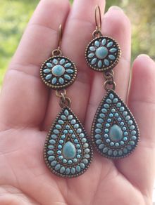 Vintage-style long bohemian drop earrings featuring turquoise enamel and a bronze-tone metal finish.