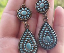 Vintage-style long bohemian drop earrings featuring turquoise enamel and a bronze-tone metal finish.