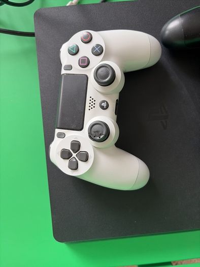 playstation 4 with two controllers and games