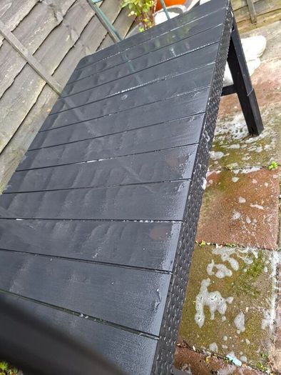 Black hard plastic garden or pargola table