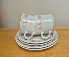Two cups, saucers and plates