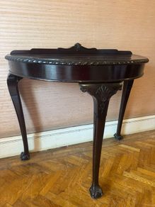 Pair of demilune console tables, mahogany finish, claw and ball feet