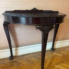 Pair of demilune console tables, mahogany finish, claw and ball feet