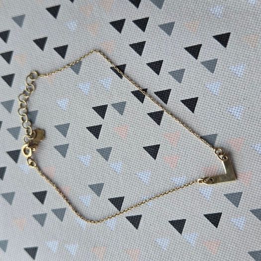 925 sterling silver bracelet with yellow gold plating and V shaped pendant.