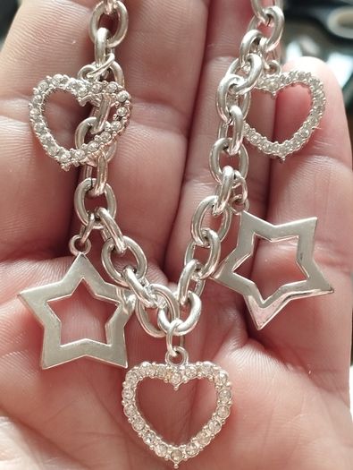 A fashionable bracelet with silver-tone charms.