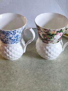 Set of 2 mugs decorative porcelain  fine bone china featuring a distinct textured, quilted or honeycomb base and intricate floral patterns.