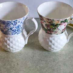 Set of 2 mugs decorative porcelain  fine bone china featuring a distinct textured, quilted or honeycomb base and intricate floral patterns.