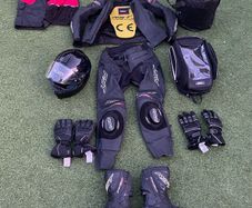 Motor cycle racing leathers with boots, gloves and helmet.