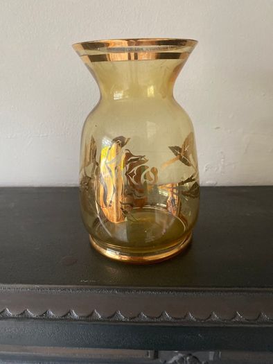 Vintage glass vase with gold decorations.