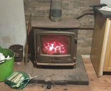 Hertage log burner stove good size works as should fluet pipe and surround with it