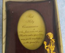 wooden photo frame commemorative plaque for a First Holy Communion. The plaque features an oval-shaped insert with a message and a small golden figure of a child praying.