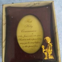 wooden photo frame commemorative plaque for a First Holy Communion. The plaque features an oval-shaped insert with a message and a small golden figure of a child praying.