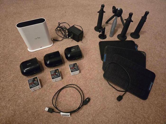 Arlo Pro 4 three cameras, a base station, solar panels