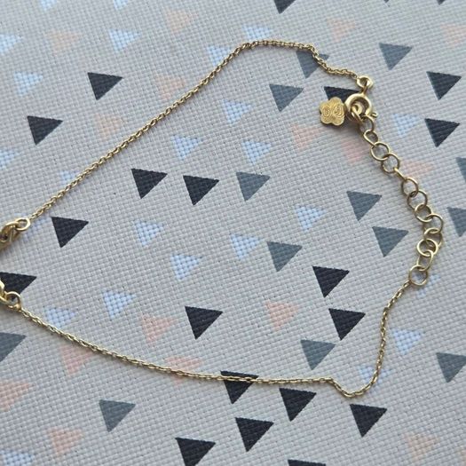 925 sterling silver bracelet with yellow gold plating and V shaped pendant.