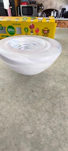 A Small Kosta Boda Art Glass Bowl with White Swirl Detail