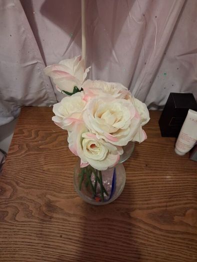 Artificial pink roses and vase