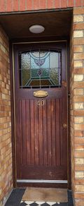 Teak front door with stained glass panel
