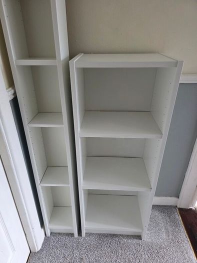 Two white shelving units (bookcase, display, other storage)