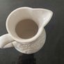 Vintage ceramic pitcher with embossed decoration Image 5