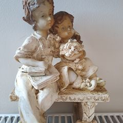 Boy and girl on bench Figurine