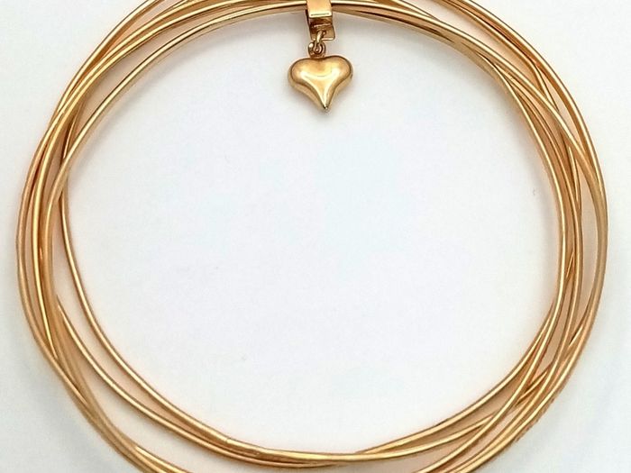 A 14K Yellow Gold Bangle Cluster Bracelet.