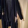long-sleeved navy garment is an oversized graphic Jacket cardigan. Image 4