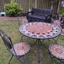 Ceramic table and four chairs. Image 2