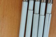 Five white extendable net curtain rods