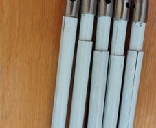 Five white extendable net curtain rods
